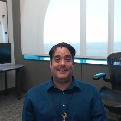 Jordan Smith sitting in an office, smiling at the camera.